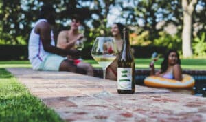 Wade Cellars' Three by Wade Chenin Blanc bottle with glass poolside
